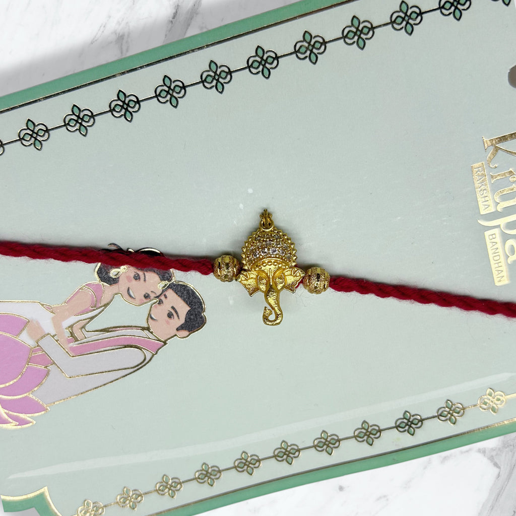 Golden Stone-Studded Ganesha Resham Rakhi