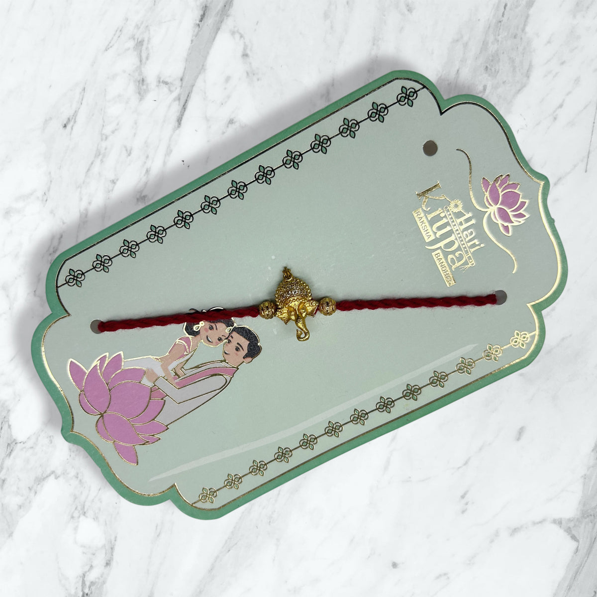 Golden Stone-Studded Ganesha Resham Rakhi